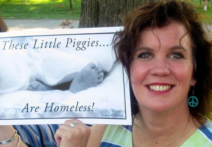 Pat LaMarche with "These Little Piggies Are Homeless" poster Poster photo by Pat Van Doren